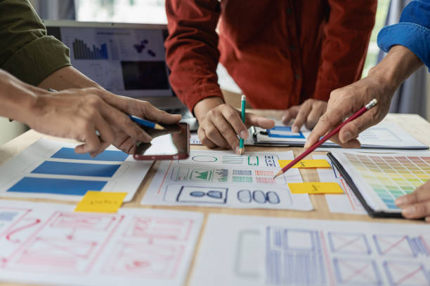istock A team of UX designers works on a new website layout. Plan mobile web application development in prototyping. product development and adding new ideas 2153302214