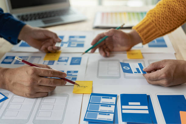 istock A team of UX designers works on a new website layout. Plan mobile web application development in prototyping. product development and adding new ideas 2153302226