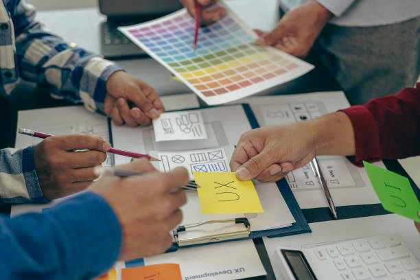 istock A team of UX designers works on a new website layout. Plan mobile web application development in prototyping. product development and adding new ideas 2153302236