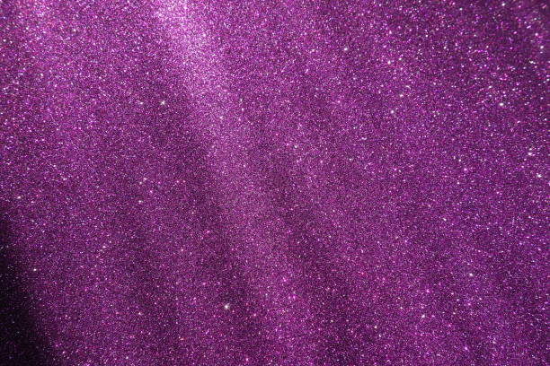 istock Oblique rays of light on a purple lilac surface. Bokeh, dust particles, reflection magical glow. Festive shining background. New Year, Christmas, birthday. Plastic card design. Cosmic photons space 2153302615