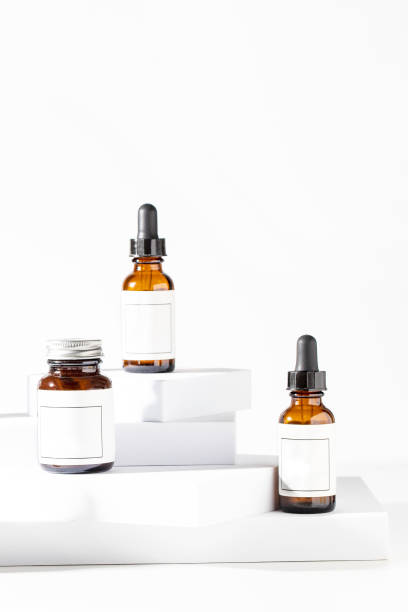 istock Three dropper bottles  with pipette on the podium  at  the white podium for cesmetic routine skincare concept 2153302666