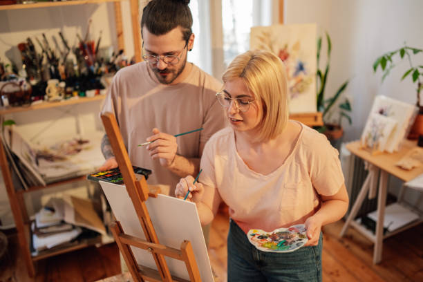 istock Focused couple painting together at creative art studio and bonding. 2153302790