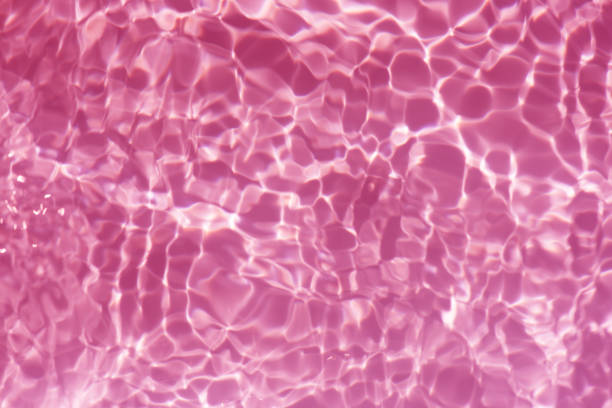 istock Bluewater waves on the surface ripples blurred. Defocus blurred transparent blue colored clear calm water surface texture with splash and bubbles. Water waves with shining pattern texture background. 2153310983
