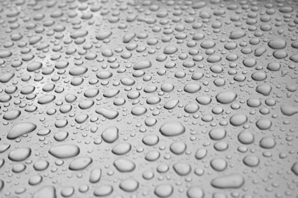 istock Rainwater Droplets on Shiny Metallic Chrome Silver Background. 2153318125