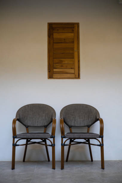 istock Two brown chairs are placed next to each other on a white background with a small window. except copy area 2153318768