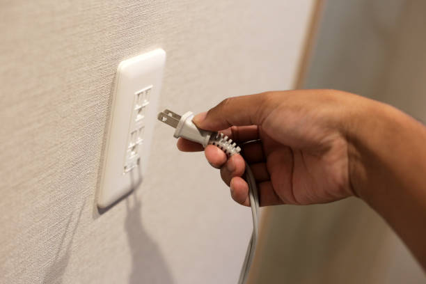 istock Hand insert a plug of the phone charger into socket. 2153322840