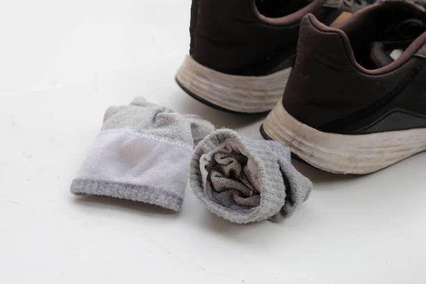 istock Black sneakers with dirty socks 2153323222