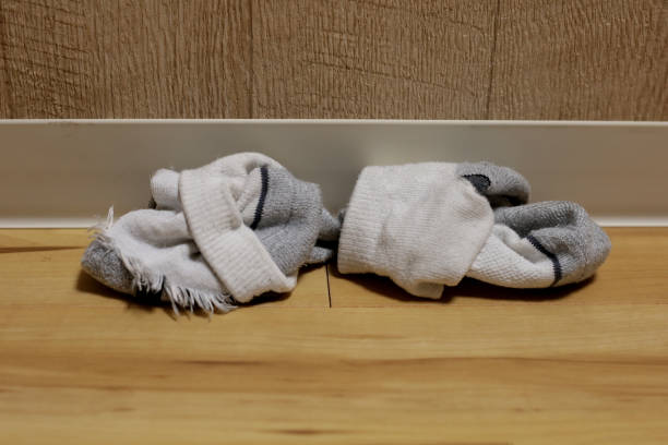 istock Dirty white socks on room floor 2153324734