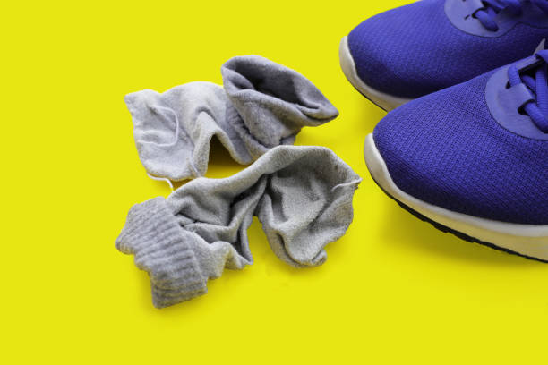 Two pairs of black canvas sneakers with white laces and rubber soles are positioned stylishly on a white background. Perfect for daily use or active outings, these shoes combine comfort and versatility for any casual occasion.