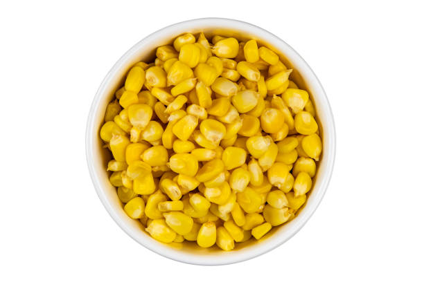 istock Top view of fresh corn seeds in white ceramic bowl isolated on white background. 2153329417