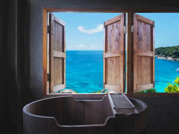 Balcony With Lounge Chairs And Seaview Through An Arch