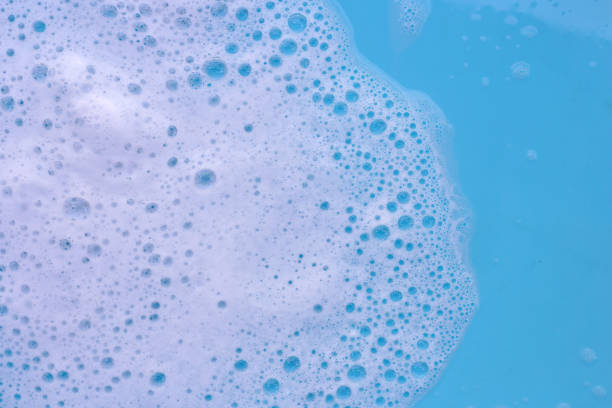 istock Detergent foam bubble on water. Blue background, Soap sud 2153330874