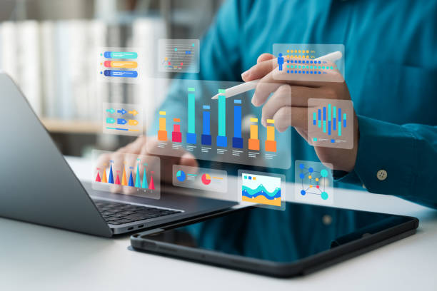 istock Businessman using laptop and tablet to analyze business data, business data dashboard. 2153334033