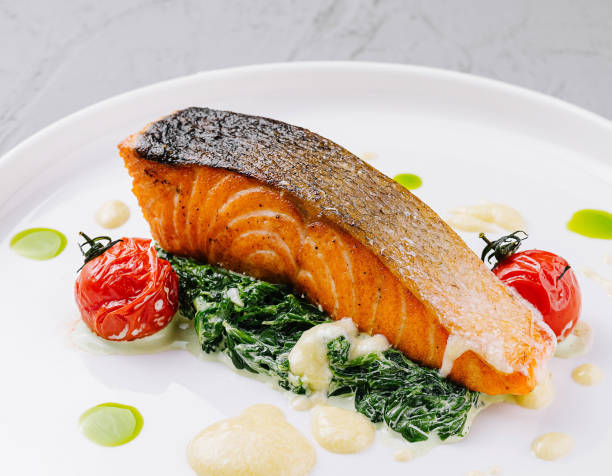 istock Gourmet grilled salmon with spinach and tomatoes 2153335660