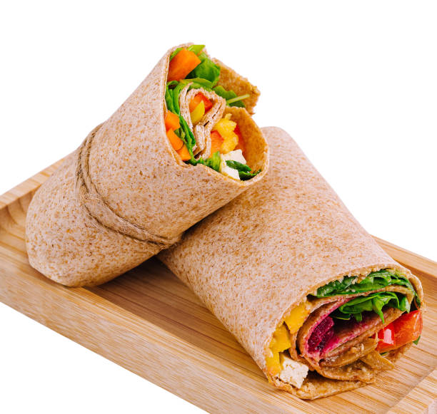 Fresh chicken wrap sandwich on wooden board