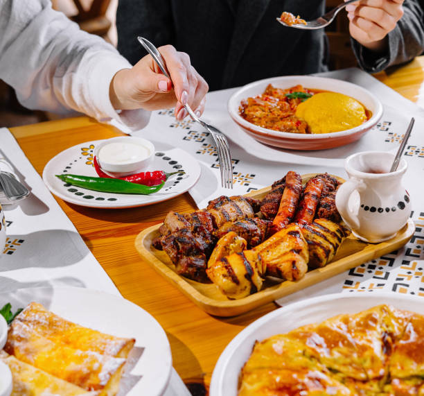 istock Friends enjoying a feast at a restaurant 2153336325