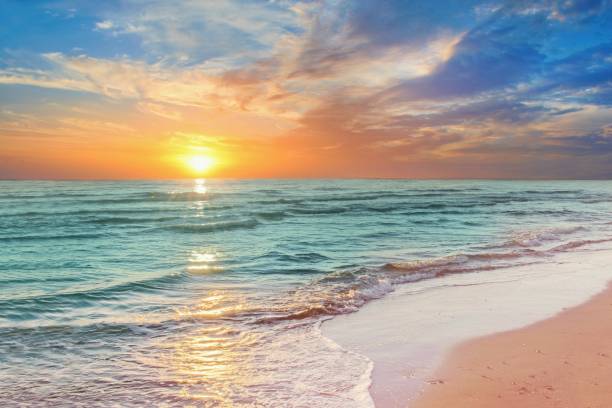 istock Colorful sunset viewed from the pink sea beach with soft waves 2153336488