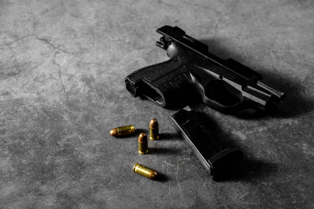 istock 9 mm gun and ammunition on black background 2153336797