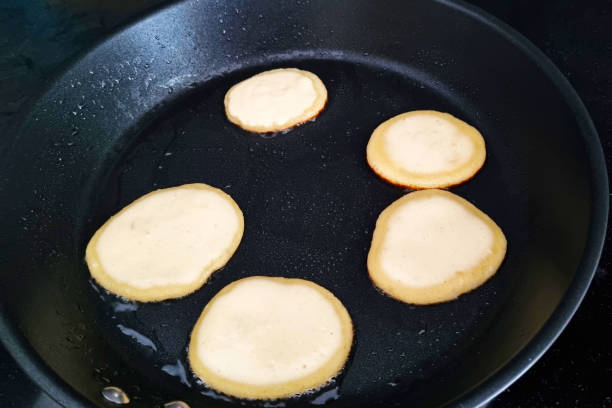 istock Delicious Mini Pancakes Cooking in a Black Non-Stick Pan 2153336855