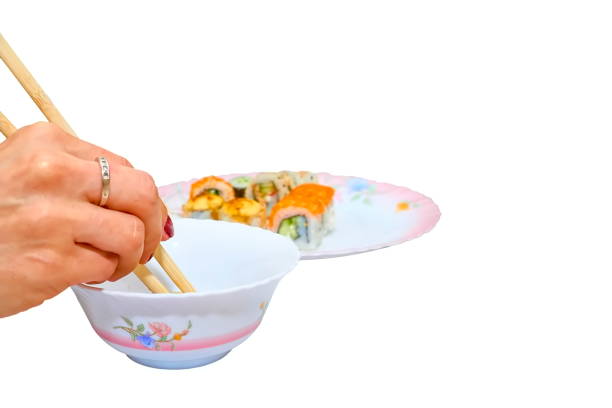 istock A woman's hand with chopsticks dips sushi into a bowl with soy sauce 2153337099