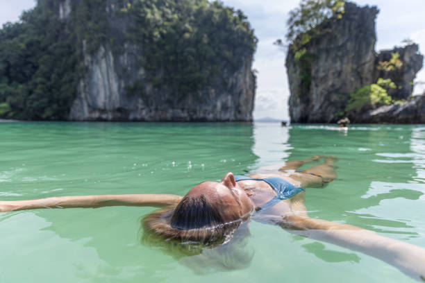 istock Woman Floating in Tropical Lagoon 2153338088