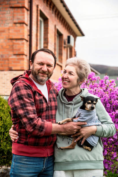 istock Mature russian married couple hugging and holding a dog 2153338430