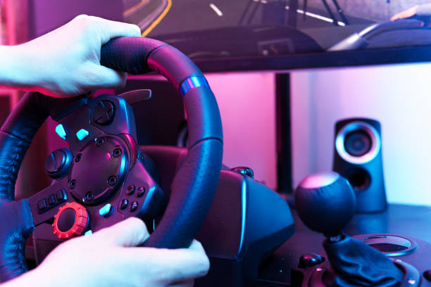 istock A person is playing a video game with a steering wheel 2153338702