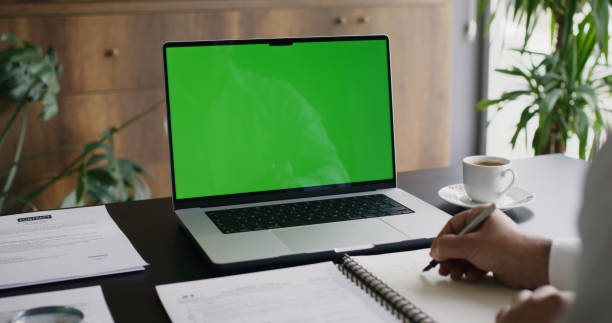 istock Businessman Using Laptop Computer With A Chroma Key Green Screen In The Office 2153340238