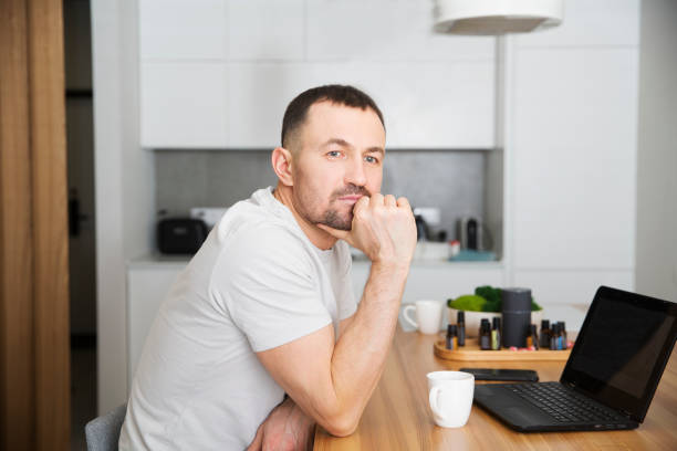 istock work from vacation home, remote workers. man using a laptop, connecting to the Internet  at home. Working from Anywhere. 2153340350