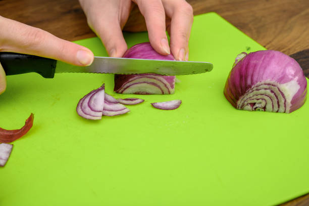 istock Red onion chopped into pieces on the kitchen counter closeup 2153340742