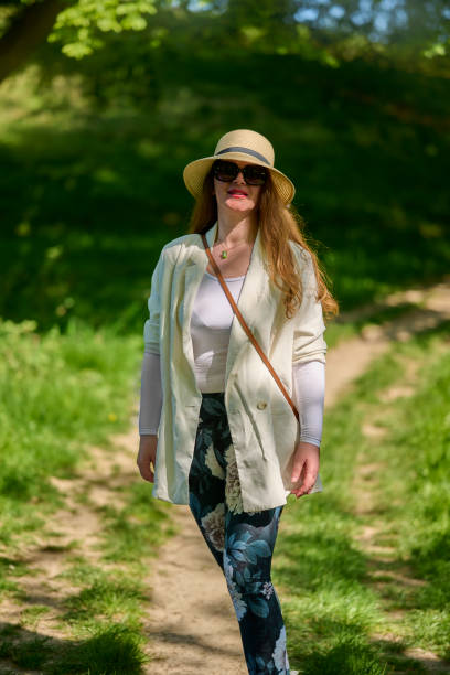 istock Woman with hat walking towards camera 2153342344