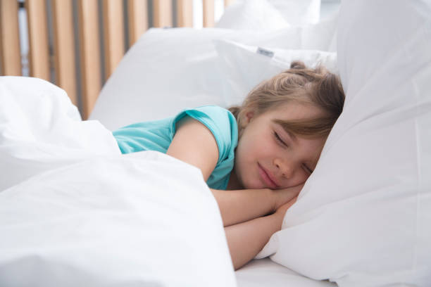 istock the child sleeps in bed 2153343602