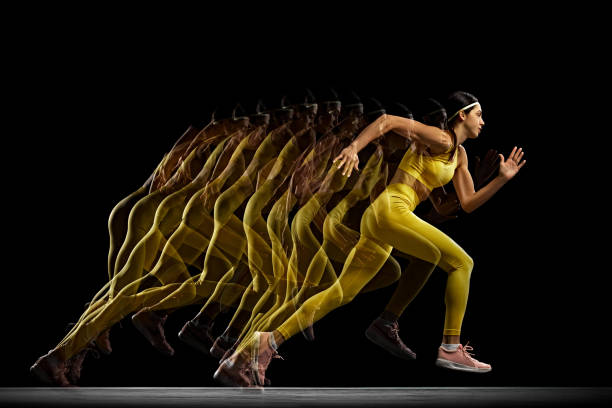 istock Athletic young woman in full motion, training, running against black background with stroboscope effect. Development of movements 2153343857