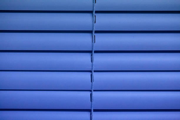 A blue blind that closes and has a single rope in the middle.