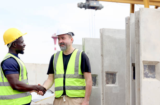 istock Harmony diversity people at workplace, senior foreman and African engineer shaking hands while inspection at construction site at construction site. Workers working together at building site. 2153350271