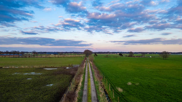 istock Twilight Descends on a Rural Pathway Framed by Pastoral Fields and Sky 2153350506
