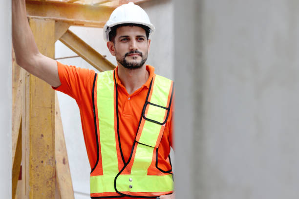 istock Happy worker engineer with safety vest and helmet inspecting working area at construction site. Architect working and checking house structure at building site workplace. Labor construction. 2153350691