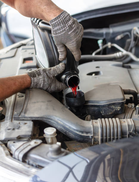 istock The master pours oil into the car's variator 2153351754