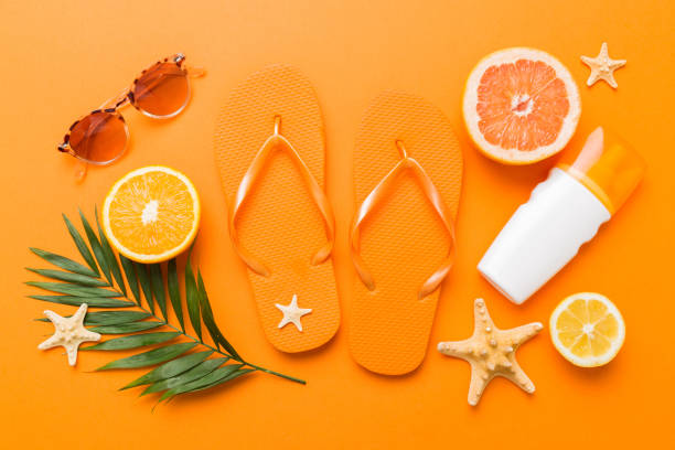 Top view composition of flip flops placed with beach accessories top view on table background. Tropical summer vacation concept Flat lay.