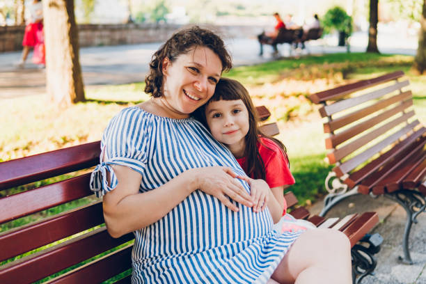 istock A daughter hugs her pregnant mother 2153353976