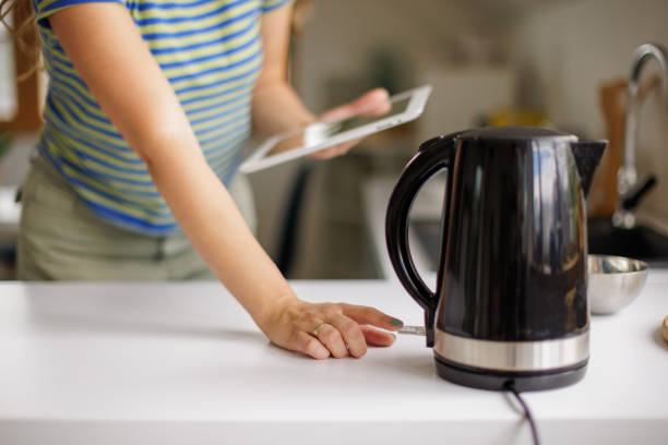 istock Woman using electric kettle at home 2153357054