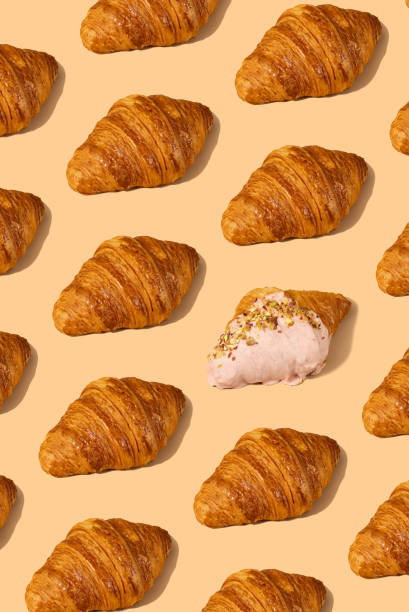 istock Fresh croissant against a pastel peach background 2153357923