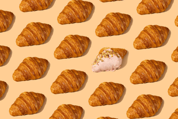 istock Fresh croissant against a pastel peach background 2153358042