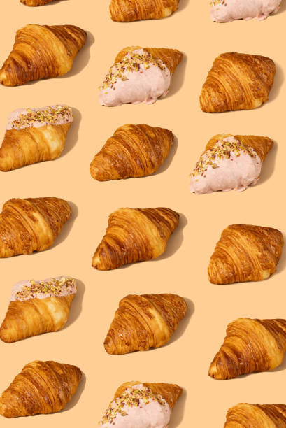 istock Fresh croissant against a pastel peach background 2153358094