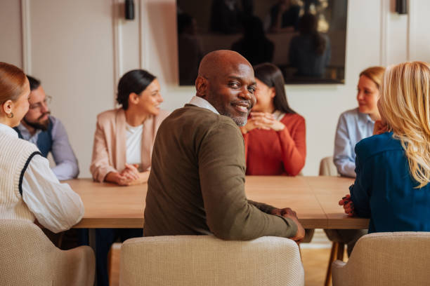 istock Businessman smiling while sitting on a work meeting 2153358132