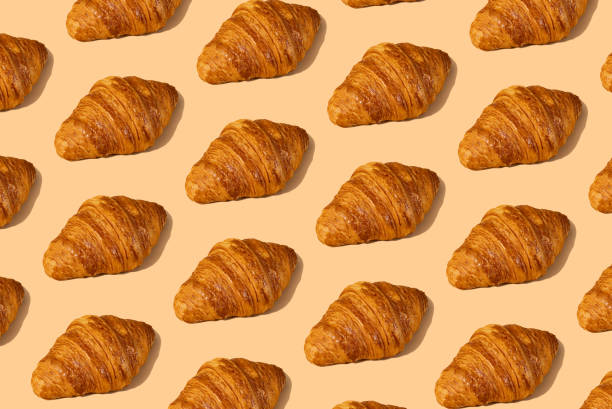 istock Fresh croissant against a pastel peach background 2153358138