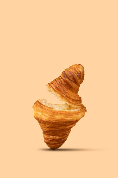 istock A split croissant levitates against a pastel peach background 2153358155
