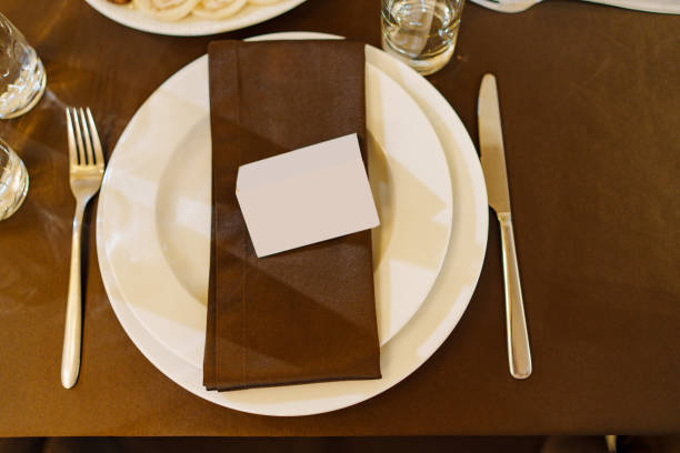 istock a plate with a brown napkin and a seating card on a served table. 2153358191