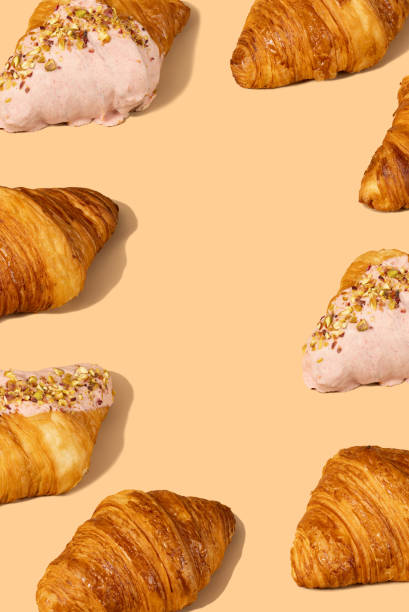 istock Fresh croissant against a pastel peach background 2153358199