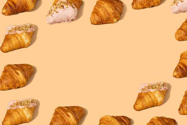 istock Fresh croissant against a pastel peach background 2153358295